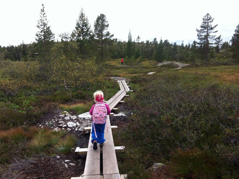 A girl walking on a mountain path at Blefjell
